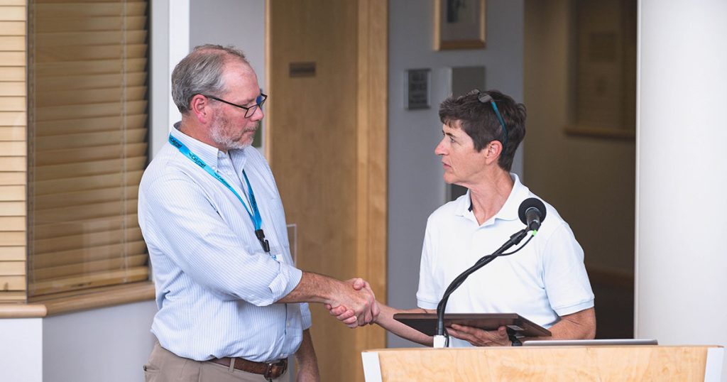 Michigan Technological University Professor Dr. Christopher Middlebrook receives an award from Adele Radcliff, Director of the Department of Defense Industrial Base Analysis and Sustainment Program (IBAS) at the Future Electronics Workforce Summit on August 17, 2022, at Michigan Tech University.